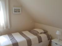 a small bedroom with a bed and a lamp at Holiday home with sea views, Plounéour-Brignogan-Plages in Plounéour-Trez