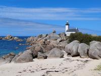 a lighthouse on top of a rocky island with the ocean at Holiday home with sea views, Plounéour-Brignogan-Plages in Plounéour-Trez