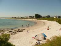 a beach with a group of people on the beach at Holiday home with sea views, Plounéour-Brignogan-Plages in Plounéour-Trez