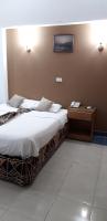 A bed or beds in a room at Marhaba Palace Hotel