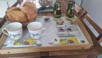 a table with a tray of food and drinks on it at Chambres d&#39;hôtes avec jacuzzi privatif in Westrehem