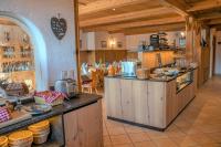 a kitchen with wooden cabinets and a counter top at Sweet Cherry - Boutique &amp; Guesthouse Tyrol in Innsbruck