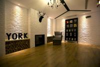 a living room with a chair and a fireplace at York Hotel in Taipei