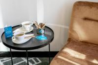 a table with two cups of coffee and a chair at Sublim by Sweet Inn in Paris