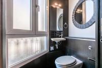 a bathroom with a toilet and a mirror at Sublim by Sweet Inn in Paris