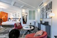 a bedroom with a bed and two chairs and a table at Sublim by Sweet Inn in Paris
