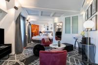 a hotel room with a bed and a table and chairs at Sublim by Sweet Inn in Paris