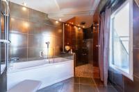 a bathroom with a tub and a shower at Sublim by Sweet Inn in Paris