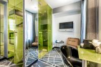 a bathroom with a shower and a television in a room at Sublim by Sweet Inn in Paris