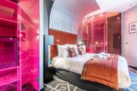 a bedroom with a large bed and a glass shower at Sublim by Sweet Inn in Paris