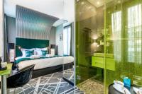 a bedroom with a bed and a glass shower at Sublim by Sweet Inn in Paris