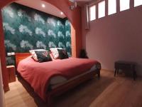 a bedroom with a bed with a red blanket at B&amp;B Au bois dormant chambres d hotes in Tillé