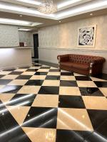 a lobby with a couch on a checkered floor at Hotel Puri in Taipei