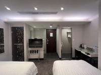 a hotel room with two beds and a bathroom at Hotel Puri in Taipei