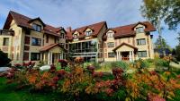 a large house with a garden in front of it at Malachit Karpacz SPA Hotel in Karpacz