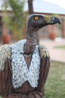 a statue of a bird standing in the grass at Manong Game Lodge in Gaborone