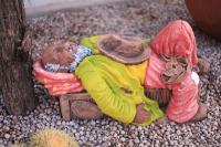 a figurine of two people sleeping on a bench at Manong Game Lodge in Gaborone