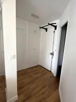 an empty room with white walls and wood floors at Appartement de standing calme - Paris - Métro 9 in Montreuil