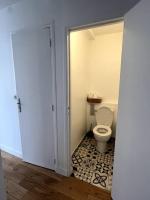 a bathroom with a toilet and a door open at Appartement de standing calme - Paris - Métro 9 in Montreuil