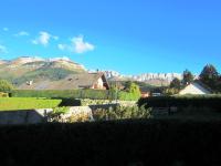 a view of a house with mountains in the background at Appartement Villard-de-Lans, 3 pièces, 6 personnes - FR-1-689-4 in Villard-de-Lans