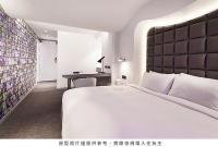 a bedroom with a large white bed and a desk at Royal Hotel Group- Central Park Branch in Kaohsiung