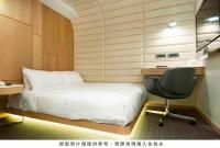 a bedroom with a bed and a desk and a chair at Royal Hotel Group- Central Park Branch in Kaohsiung
