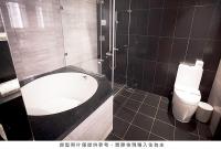 a bathroom with a bath tub and a toilet at Royal Group Hotel Minghua Branch in Kaohsiung