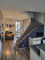 a living room with a staircase in a house at Très bel appartement cosy en hyper centre in Romorantin