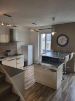 a kitchen with a large clock on the wall at Très bel appartement cosy en hyper centre in Romorantin