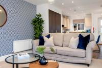 a living room with a couch and a table at NEW Berkley House by Truestays - 3 Bedroom House in Stoke-on-Trent in Etruria
