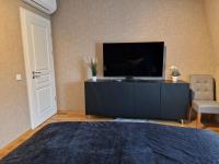 A television and/or entertainment centre at Апартамент RESORT SENSATION 3
