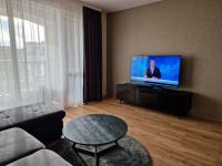 A television and/or entertainment centre at Апартамент RESORT SENSATION 3