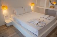 Postel nebo postele na pokoji v ubytování Aloha Suites