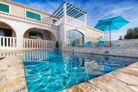 a swimming pool in front of a house at Villa Sonnhaus in Marina