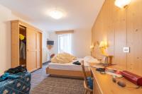 A bed or beds in a room at Albergo Canazei