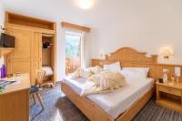 A bed or beds in a room at Albergo Canazei