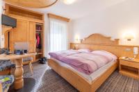 A bed or beds in a room at Albergo Canazei