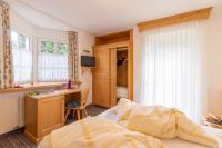 A bed or beds in a room at Albergo Canazei
