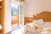 A bed or beds in a room at Albergo Canazei