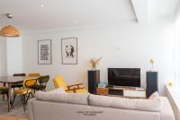 a living room with a couch and a table at Spacious bright apartment next to the sea and city centre in Ostend