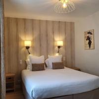 A bed or beds in a room at Logis Hotel La Closerie