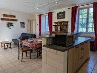 a kitchen and a dining room with a table and a kitchen gmaxwell gmaxwell at Gîte Cherves-Richemont, 3 pièces, 5 personnes - FR-1-653-205 in Cherves-de-Cognac