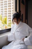 a woman dressed in white sitting in a window at Hotel Renew in Honolulu