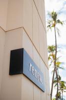 a sign for a hotel on the side of a building at Hotel Renew in Honolulu
