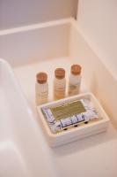 a drawer with three bottles of medicine and a scale at Hotel Renew in Honolulu