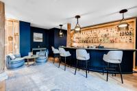 a bar with white chairs and a blue wall at Fleur de Loire in Blois
