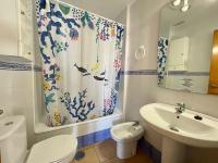 a bathroom with a sink and a toilet and a shower curtain at Apartamento Gaviotas Sureñas in Tarifa