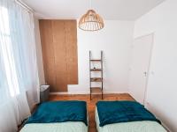 a bedroom with two beds and a light fixture at Gritxu Etxea in Biarritz