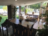 a living room with a wooden table and some plants at La Maison des Délices in Le Beausset