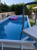 a pool with a chair and a frisbee in it at La Maison des Délices in Le Beausset